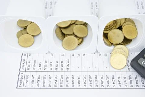 Gold coin difference amount in cup Stock Photos