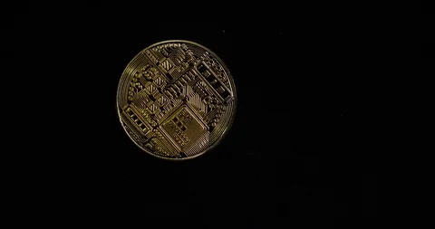 Gold coin, digital pattern rotates on black background, gold glistens in light Stock Footage 120271661