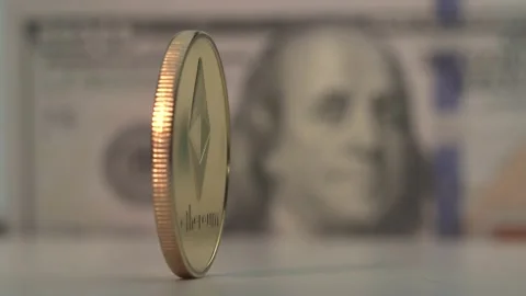 Gold coin Etherium ETH rotate on the white surface. USA dollar on the background Video stock 132319785