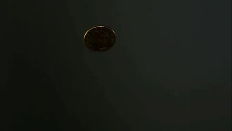 Gold coin flips through the air slowly Stock Footage 326753531