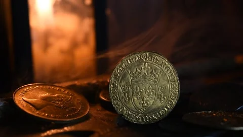 Gold Coin illuminated by candlelight. Stock Footage 333609552