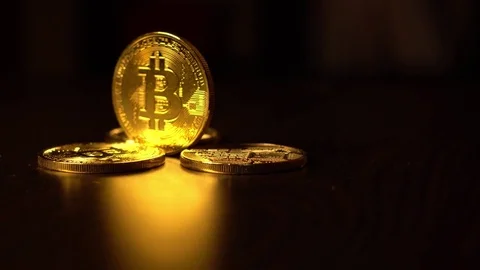 Gold coins of bitcoins on an office table on a dark background Stock Footage 82014232