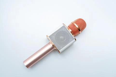 A gold colored wireless microphone Stock Photos