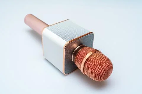 A gold colored wireless microphone Stock Photos