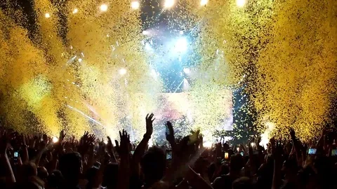 Gold confetti floating in the air during a concert Stock Footage