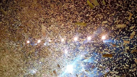 Gold confetti floating in the air during a concert Stock Footage