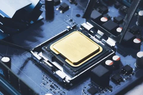 Gold CPU processor chip in connector socket on the computer motherboard and c 스톡 사진
