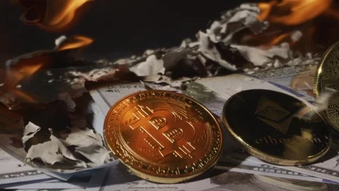 Gold crypto coins fall on 100 dollar bills with fire burning in background Stock Footage 291944978