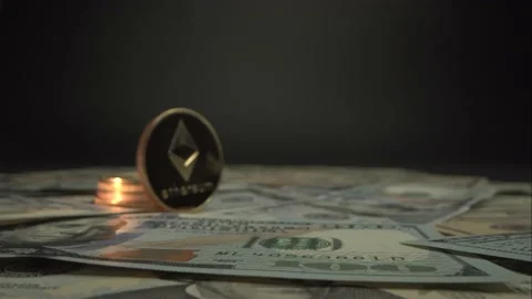 Gold Crypto money Etherium ETH stay surrounded by hundred dollars US. Camera Stock Footage 129826980