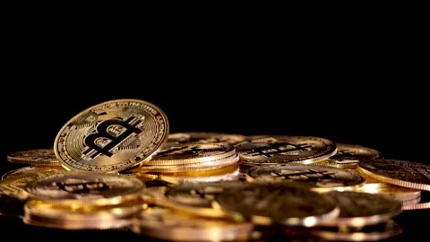 Gold Cryptocurrency Coin Dropping Onto Stack of Coins Stock Footage 315743754