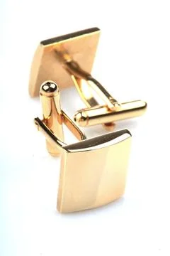 Gold cuff links on white background Stock Photos