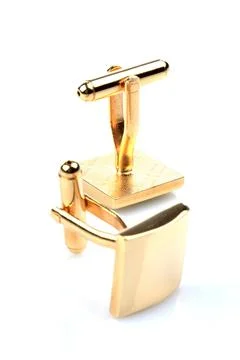 Gold cuff links on white background Stock Photos