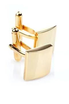 Gold cuff links on white background Stock Photos