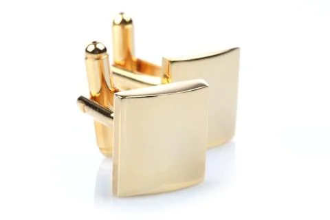Gold cuff links on white background Stock Photos