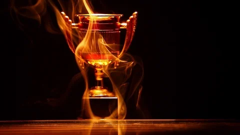 Gold cup smoke reflection dark background nobody hd footage Stock Footage 100755406