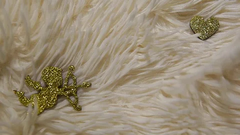 Gold cupid heart wool background hd footage Stock Footage 124146431