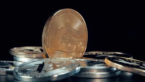 Gold Dash coin on black background. Silver Crypto coin on spinning stand. Stock Footage 126906172