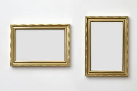 Gold decorative picture frames on white wall Stock Photos