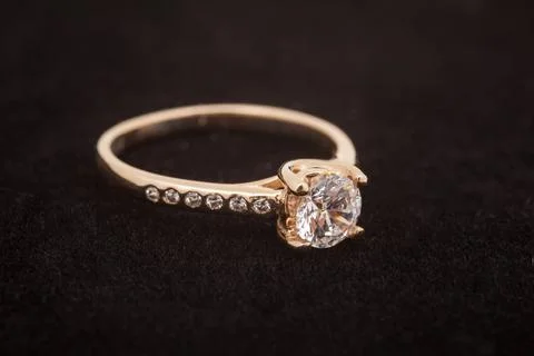 Gold diamond ring on dark background. Engagement ring Stock Photos