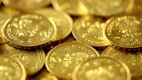 Gold Eagle one ounce coins being poured down onto a pile of other golden money Video stock 334027946