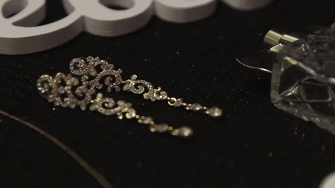 Gold earrings on a dark background Video stock 73780234