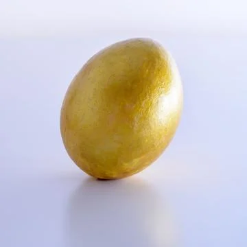 Gold easter-egg on white background Stock Photos