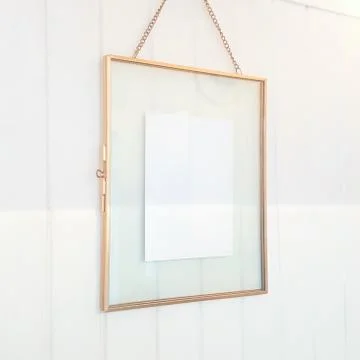 Gold Floating Framed Post Card on White Wood Wall Stock Photos