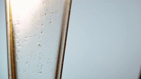 Gold Fluid With Microbubbles Slowly Flow Downward In Gray Background. - Stock Footage 140248740