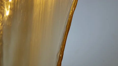 Gold Fluid, Oil Dripping Down With Bright Reflections Of Lights. - macros Stock Footage 140486499