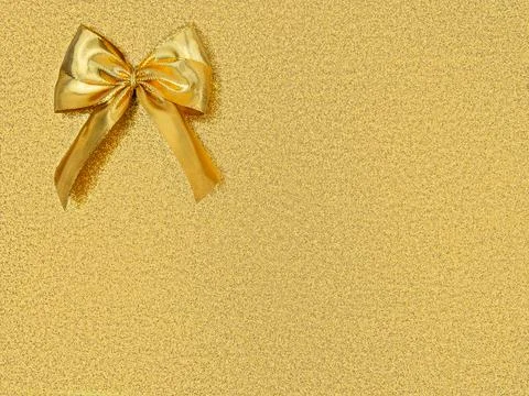 Gold foil bow in upper corner of shiny shimmering golden copy space,pattern Stock Photos