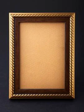 Gold frame over black background Stock Photos