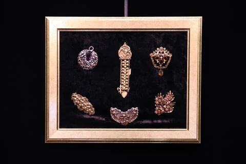 Gold frame on the wall, which is placed with vintage jewelry Stock Photos