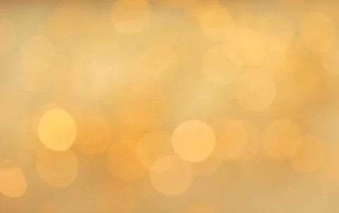 Gold glitter with bokeh effect on light background Stock Photos