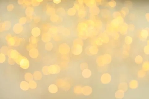 Gold glitter with bokeh effect on light background Stock Photos