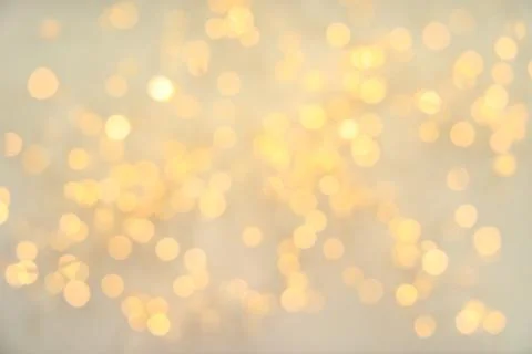 Gold glitter with bokeh effect on light background Stock Photos