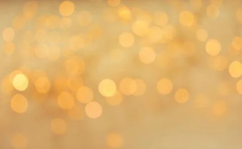 Gold glitter with bokeh effect on light background Stock Photos