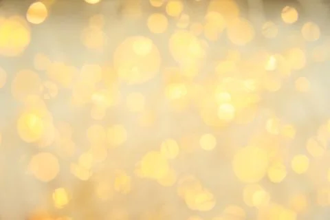 Gold glitter with bokeh effect on light background Stock Photos