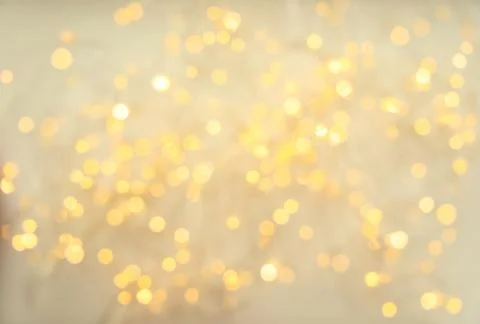 Gold glitter with bokeh effect on light background Stock Photos