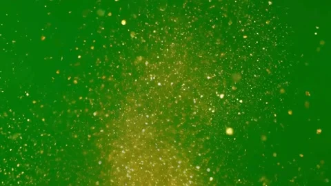 Gold glitter dust explodes upwards on green screen background Stock Footage 331766671