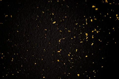 Gold glitter texture on a black background. Holiday background. Golden explos Stock Photos