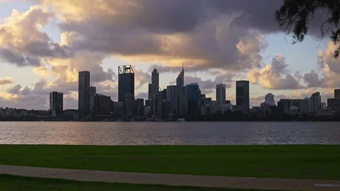 Gold grey clouds at dusk over city, river. Timelapse of walkers speeding past Stock Footage 279286565