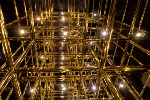 Gold grid on a black background Stock Photos