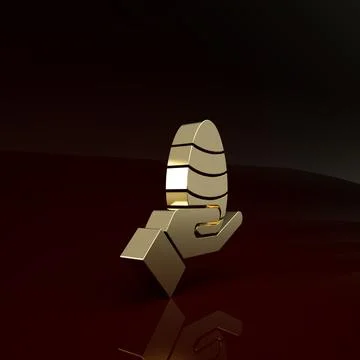 Gold Human hand and easter egg icon isolated on brown background. Happy Easte Illustrazione stock