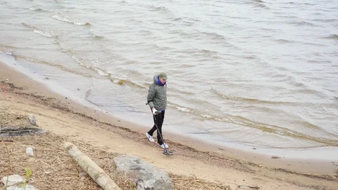 Gold hunter using metal detector on beach Stock Footage 111189853