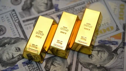 Gold ingots and dollars on a table Stock Footage