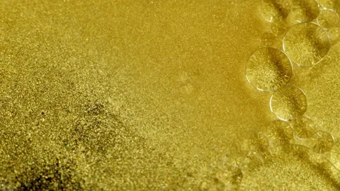 Gold Ink Particles abstract background with oil bubbles, close-up Stock-Footage 130378371