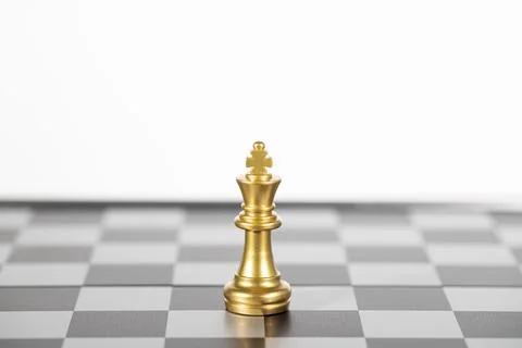 The gold king chess alone on the chess board , business strategy Stock Photos
