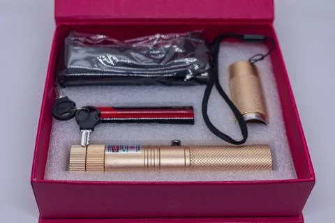 Gold Laser Pointer Set with Keys and Accessories in Red Gift Box on White Ba Stock Photos