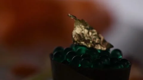 Gold leaf on a mint capsule dessert Stock Footage 132555231