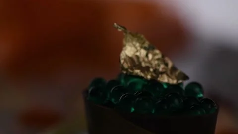 Gold leaf mint capsules gently illuminated. Stock Footage 132555227
